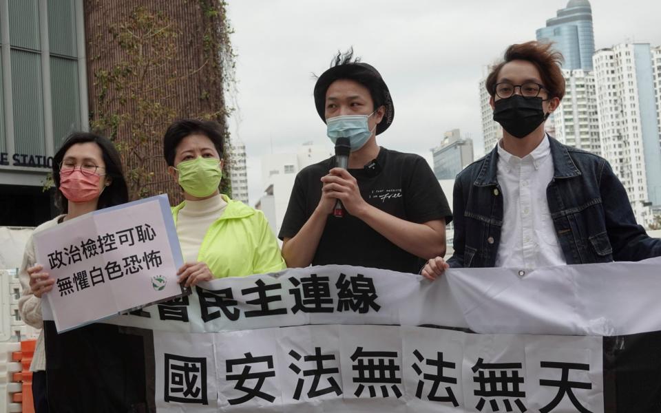 Pro-democracy activists Helena Wong Pik-wan and Jimmy Sham arrive to report to a police station over national security law charges -  JOYCE ZHOU/REUTERS