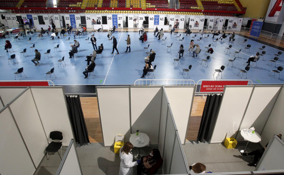 A sports arena has been transformed into a COVID-19 vaccination center, at A1 Arena in Skopje, North Macedonia, on Monday, April 5, 2021. The tiny Balkan country has begun administrating mass immunization of the army, police and media workers on Monday with about 20,000 doses of Russian Sputnic V donated from neighboring Serbia. (AP Photo/Boris Grdanoski)