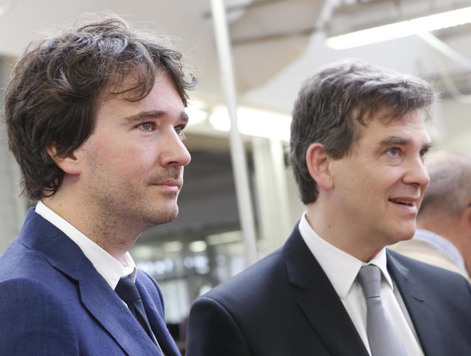 LVMH member of the board of directors Antoine Arnault, left, to French Minister for Industrial Recovery Arnaud Montebourg, listen during a visit of "Particular operation days" in LVMH, the world's largest luxury company at the factory of Vuitton, in Asnieres north of Paris Saturday June 15, 2013.(AP Photo/Jacques Brinon)