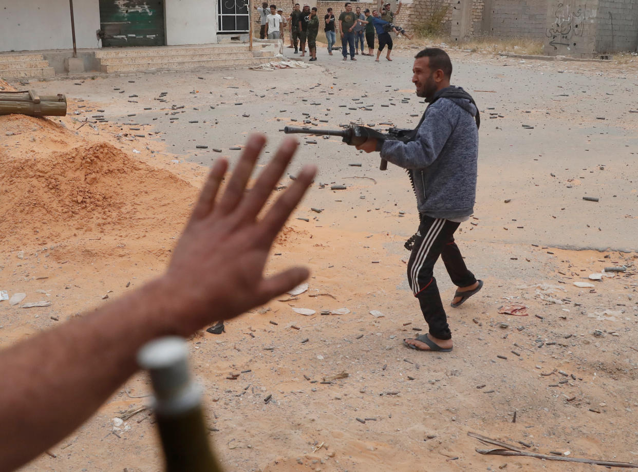 A fighter loyal to Libya's U.N.-backed government (GNA) fires a weapon during a clash with forces loyal to Khalifa Haftar at the outskirts of Tripoli, Libya May 21, 2019. (Photo: Goran Tomasevic/Reuters)