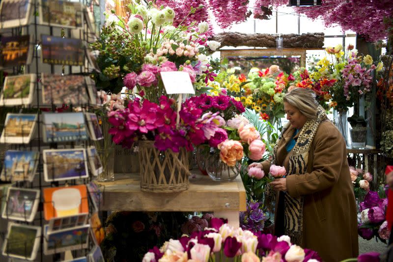 FILE PHOTO: A woman visits the floating flower market in Amsterdam