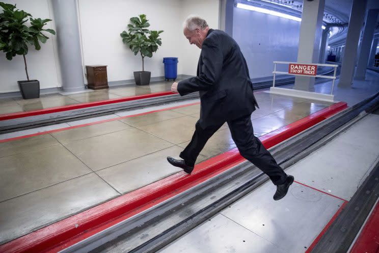 Sen. Jerry Moran, R-Kan., jumps over the Senate subway tracks to evade reporters as he arrives on Capitol Hill in Washington on Tuesday. Moran's leap follows the collapse of the health care bill, in which he played a key role. (Photo: Andrew Harnik/AP)