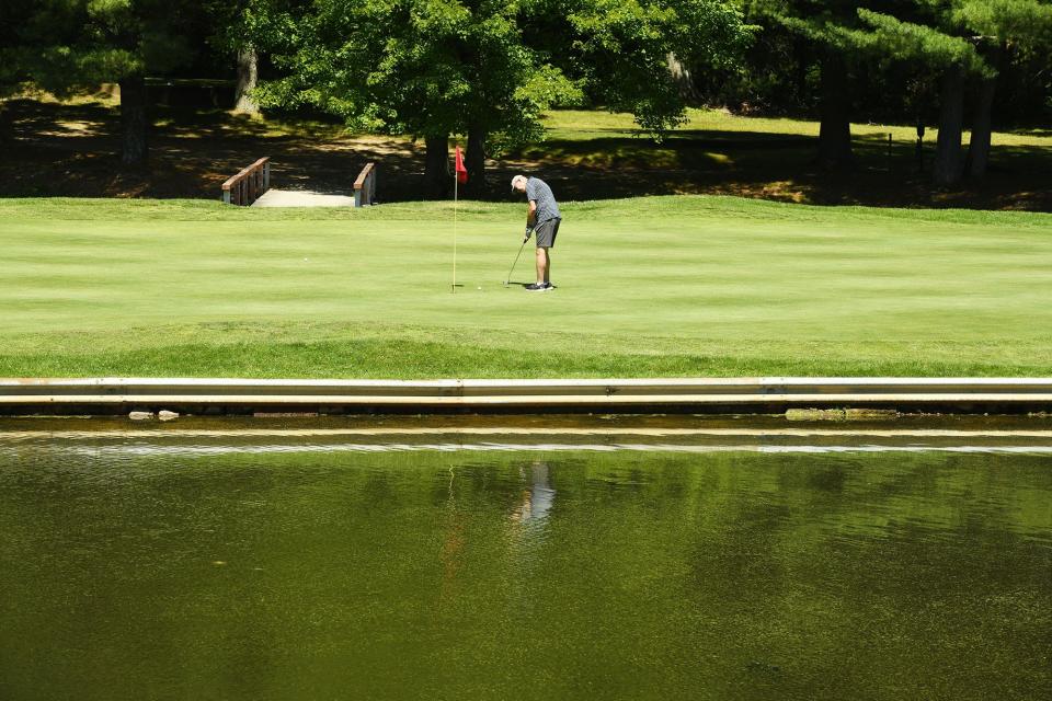 A golfer putts on the fourth hole at Chanticlair Golf Course in Colchester.
(Photo: [John Shishmanian/ NorwichBulletin.com])