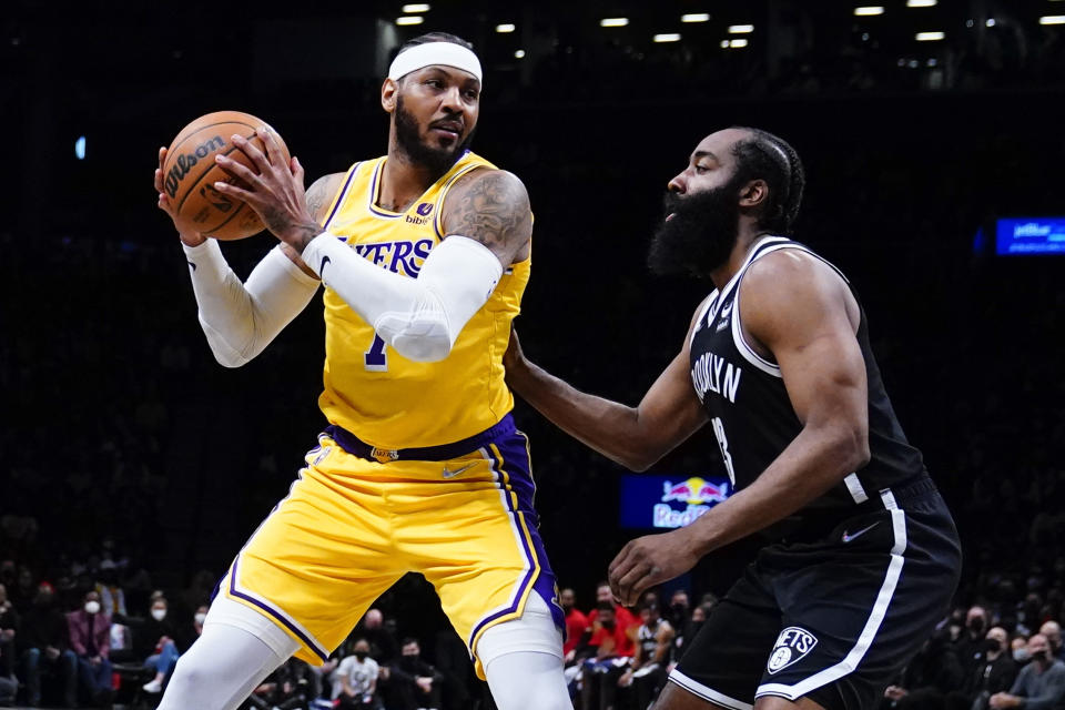 Brooklyn Nets' James Harden, right, defends Los Angeles Lakers' Carmelo Anthony, left, during the first half of an NBA basketball game Tuesday, Jan. 25, 2022 in New York. (AP Photo/Frank Franklin II)