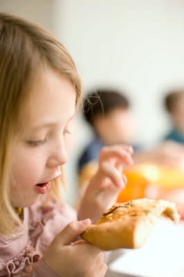 A tester investigates one of Gourmet's pizzas.