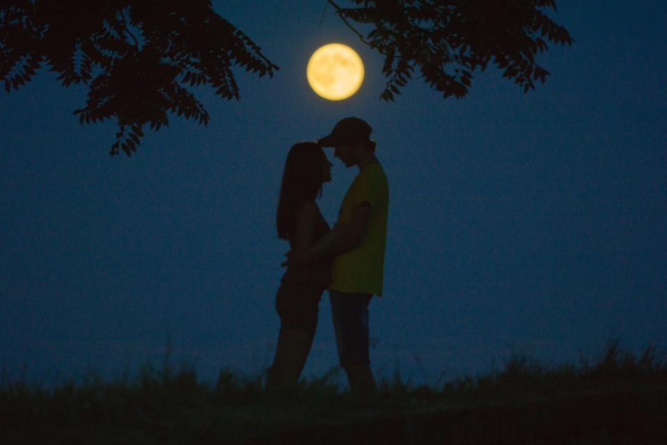 A couple hug under a full moon in Kalimegdan Park in Belgrade, Republic of Serbia. 
