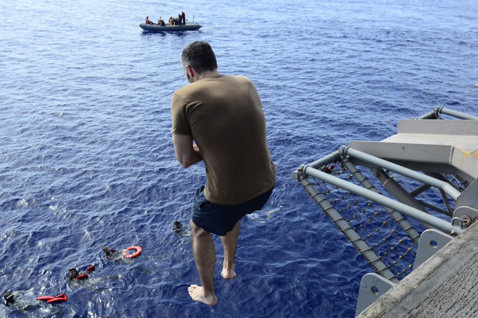 In this May 16, 2020, photo provided by the U.S. Navy, Sailors participate in a swim call on the aircraft carrier USS Dwight D. Eisenhower (CVN 69) in the Persian Gulf. When coronavirus made U.S. Navy ship stops in foreign countries too risky, the USS Dwight D Eisenhower and the USS San Jacinto were ordered to keep moving, and avoid all port visits. More than five months after they set sail, they have broken a record they never planned to achieve. As they steamed through the North Arabian Sea on June 25, they notched their 161st consecutive day at sea, breaking the previous Navy record of 160 days. (Mass Communication Specialist 1st Class Tony D. Curtis/U.S. Navy via AP))