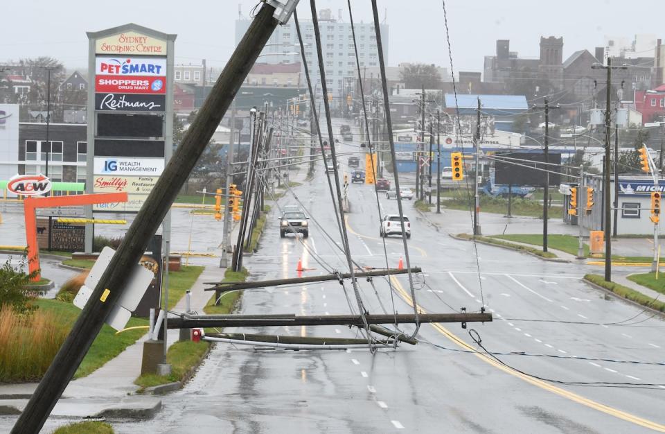 Downed power poles blocking part of a road in Glace Bay, Nova Scotia on Sunday September 25, 2022. A day after post-tropical storm Fiona left a trail of destruction through Atlantic Canada and eastern Quebec, residents of a coastal town in western Newfoundland continued to pick through wreckage strewn across their community, easily the most damaged area in the region. 