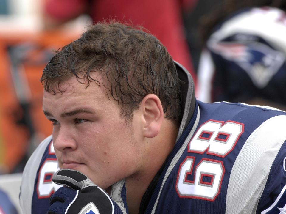 Ryan O'Callaghan in uniform, resting his head on his hands.