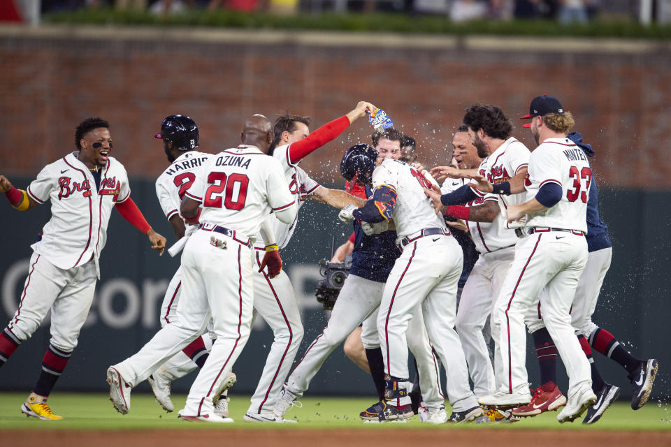 Atlanta Braves celebrate a walk off RBI single by Adam Duvall during the ninth inning of a baseball game against the San Francisco Giants Wednesday, June 22, 2022, in Atlanta. (AP Photo/Hakim Wright Sr.)