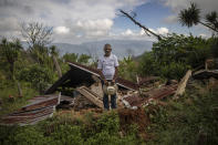 Julio Villanueva Melgar, 70, stands for a portrait among the remains of his home destroyed by a landslide triggered by hurricanes Eta and Iota in the village of La Reina, Honduras, Wednesday, June 23, 2021. Over the decades, he raised a family and made a living in La Reina. But now he feels as if he’s been hurled into a new and more hostile universe. “One becomes crazy, disoriented. ... You don’t fit in anymore.” (AP Photo/Rodrigo Abd)