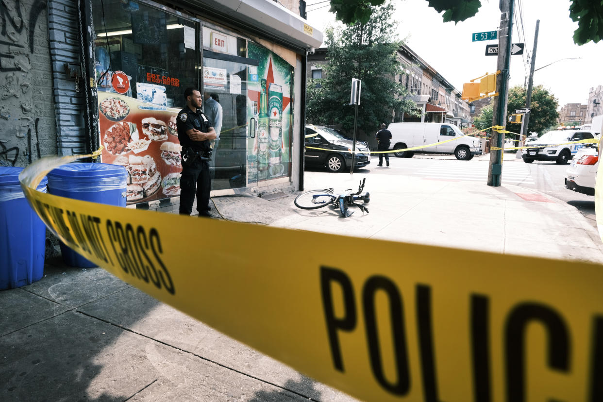 Police converge on the scene of a shooting in Brooklyn, one of numerous during the day, on July 14, 2021 in New York City. (Spencer Platt/Getty Images)