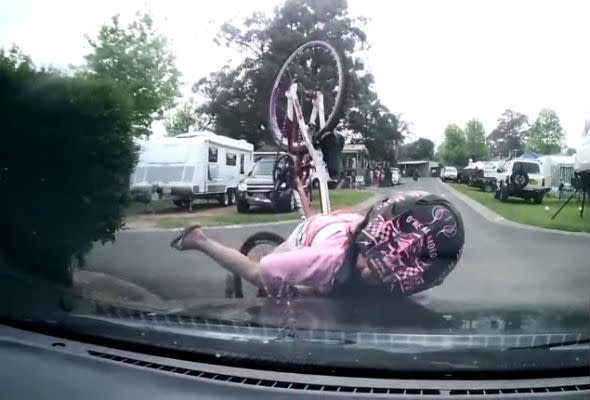 Girl cycles into car