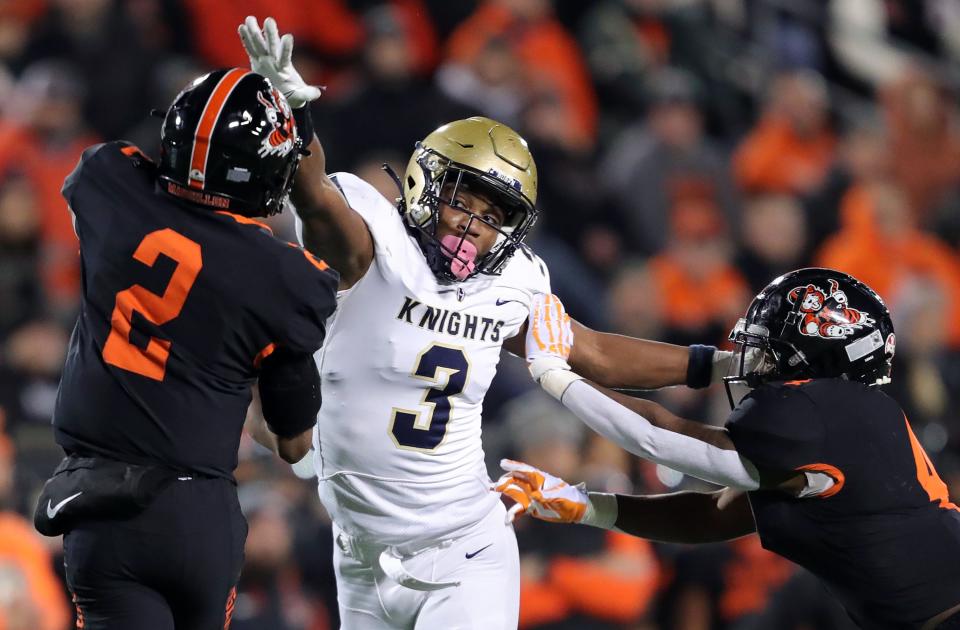 Hoban linebacker Rickey Williams (3) attempts to get his hand on a pass thrown by Massillon quarterback Jalen Slaughter during an OHSAA Division II state semifinal on Nov. 25, 2022, in Akron.