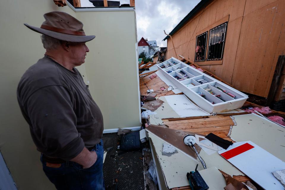 Mel Gilmer surveys the damage to his business after a tornado passed through downtown Selma, Ala., Thursday, Jan. 12, 2023. Gilmer took shelter in the bathroom as the tornado hit.