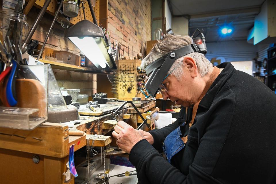 Jeweler Mary Dunker, of Linn & Owen Jewelers, works on a ring Wednesday, Jan. 31, 2024. She has worked at the downtown Washington Square jewelry store for 38 years.