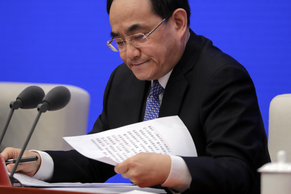 Xu Lin, Vice head of the Publicity Department of Communist Party looks at his notes during a press conference on the white paper on fighting COVID-19 China in action, at the State Council Information Office in Beijing, Sunday, June 7, 2020. Senior Chinese health officials defended their country's response to the new coronavirus pandemic, saying they provided information in a timely and transparent manner. (AP Photo/Andy Wong)