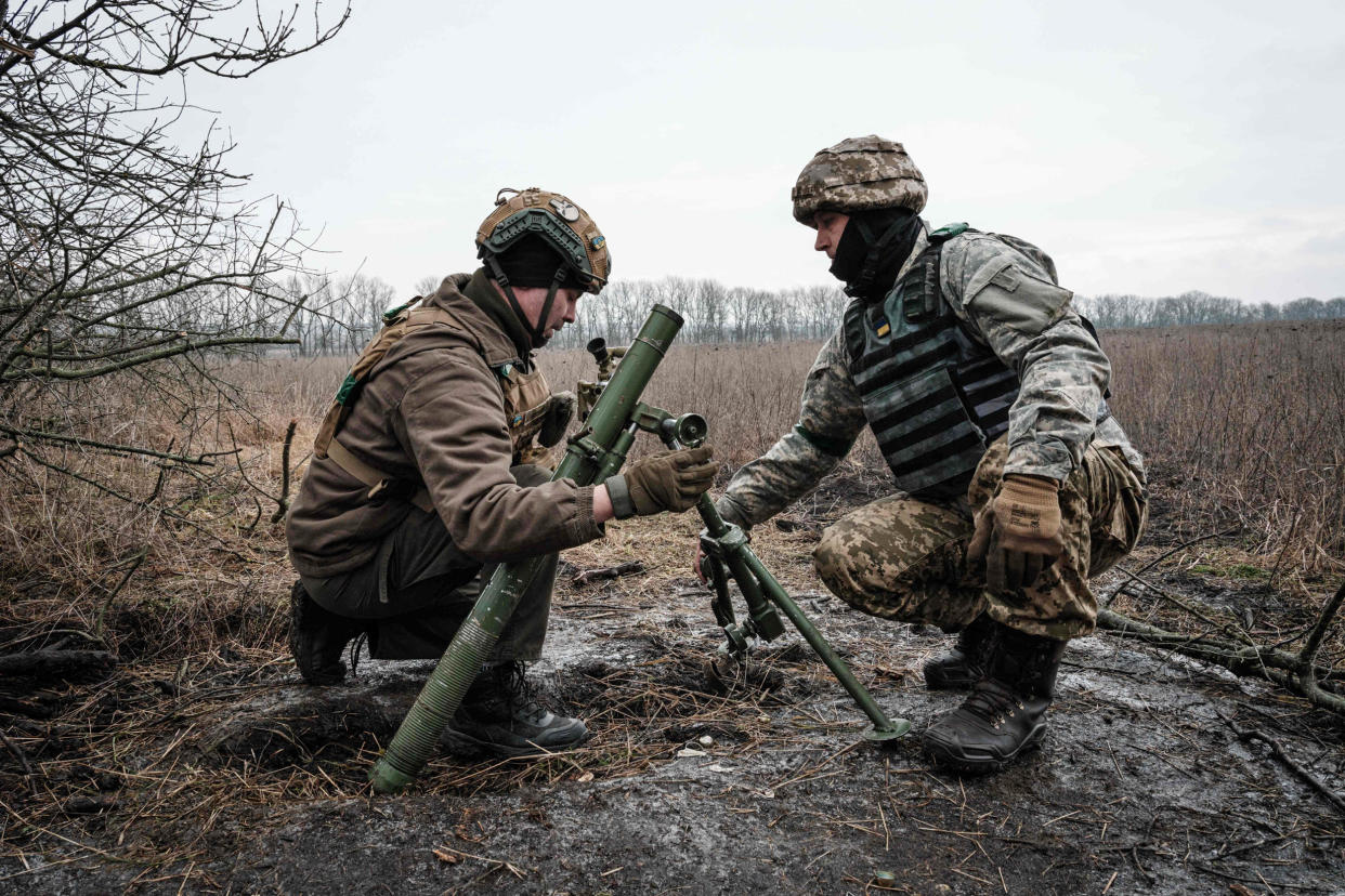 Ukrainian soldiers adjust a 60mm mortar tube near the frontline in the Donetsk region on Jan. 31, 2023.  (Yasuyoshi Chiba  / AFP - Getty Images)