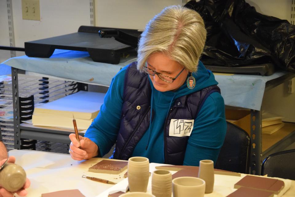 Liz Racignol, an art teacher from Petoskey Middle School, works on a design during the pottery workshop held by Crooked Tree Arts Center on April 15, 2024.