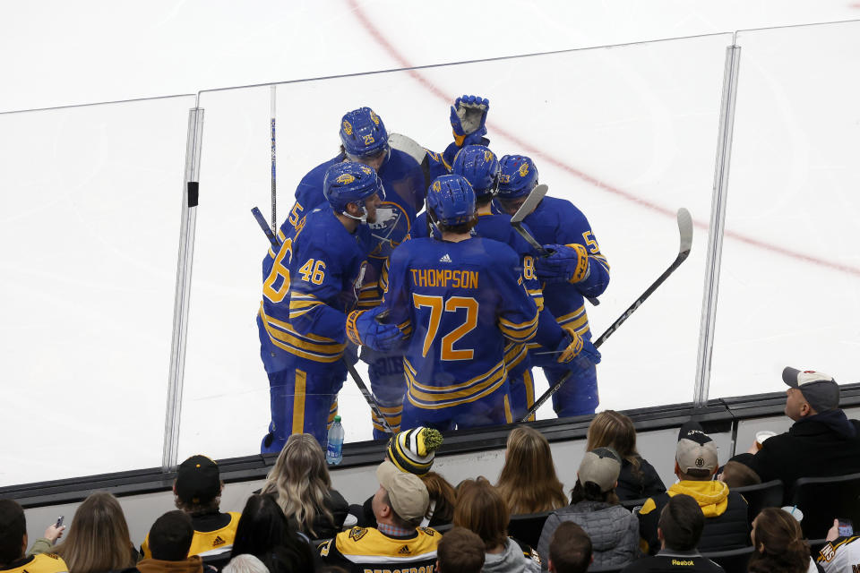 Buffalo Sabres player surround Alex Tuch after he scored a goal against the Boston Bruins during the second period of an NHL hockey game, Saturday, Dec. 31, 2022, in Boston. (AP Photo/Mary Schwalm)