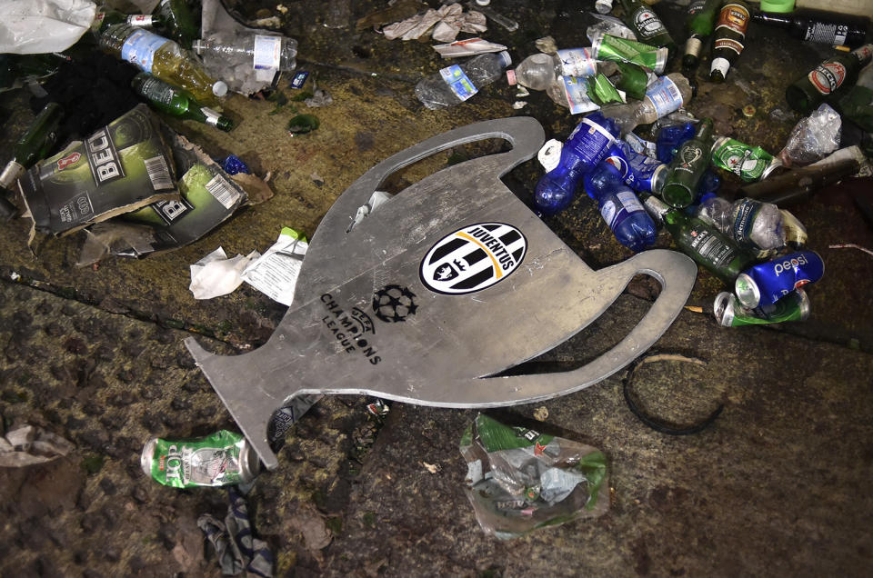 <p>Football Soccer – Juventus v Real Madrid – UEFA Champions League Final – San Carlo Square, Turin, Italy – June 3, 2017 A cardboard shaping the Champions League cup is seen on the ground left in San Carlo Square by crowd gather to watch the match and ran away following panic created by the explosion of firecrackers on June 3, 2017. (Giorgio Perottino/Reuters) </p>