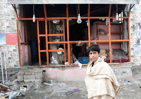 An Afghan boy walks past a damaged bakery at the site of a car bomb blast in Kabul, Afghanistan January 15, 2019.REUTERS/Mohammad Ismail