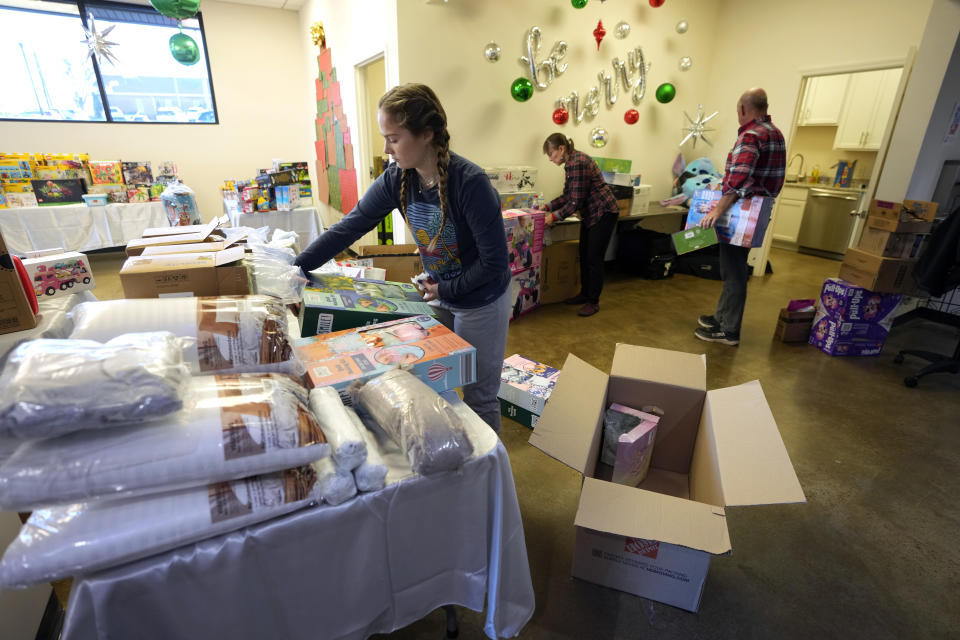 Molly Armbrecht, left, arranges toys at The Toy Store, a free-referral based toy store Thursday, Dec. 7, 2023, in Nashville, Tenn. The facility is co-founded by Brad Paisley and Kimberly Williams-Paisley. The couple also started The Store, a free-referral based grocery store they opened in partnership with Belmont University in March 2020. (AP Photo/Mark Humphrey)