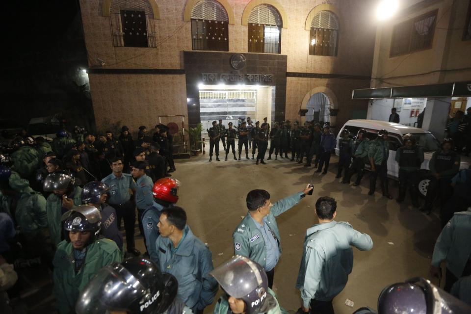 Police officers stand guard in front of the central jail in Dhaka