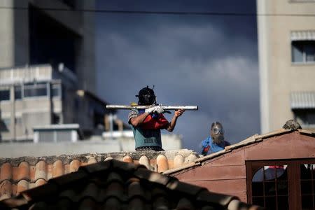 A demonstrator uses a makeshift weapon at a rally during a strike called to protest against Venezuelan President Nicolas Maduro's government in Caracas. REUTERS/Ueslei Marcelino