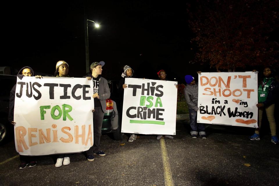 Demonstrators protest the killing of 19-year-old Renisha McBride outside the Dearborn Heights Police Station