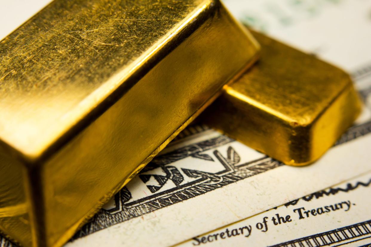 Closeup of gold bars on top of U.S. dollar