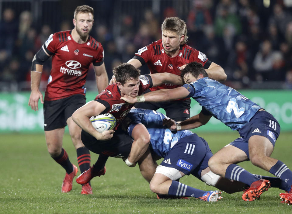 Crusaders George Bridge is tackle day the Blues defence during the Super Rugby Aotearoa rugby game between the Crusaders and the Blues in Christchurch, New Zealand, Saturday, July 11, 2020. (AP Photo/Mark Baker)