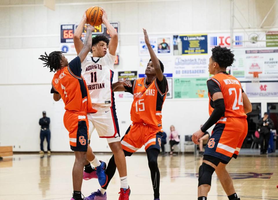 Modesto Christian’s Gavin Sykes is swarmed by Cosumnes Oaks defenders during the Sac-Joaquin Section Division I playoff game at Modesto Christian High School in Salida, Calif., Wednesday, Feb. 14, 2024.