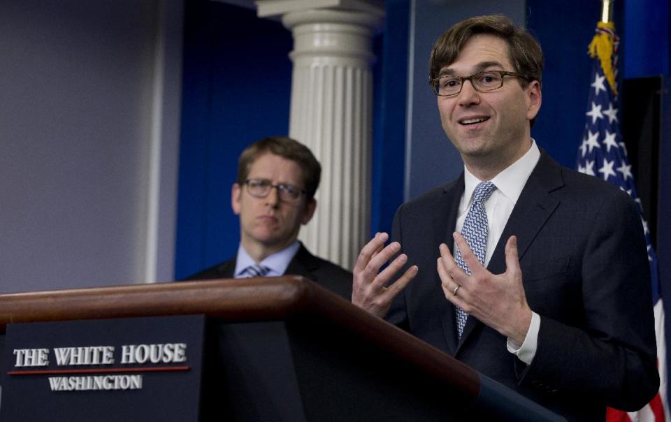 Chairman of the Council of Economic Advisers Jason Furman, right, accompanied by White House press secretary Jay Carney, speaks during the daily news briefing at the White House in Washington, Tuesday, Feb. 4, 2014, about the Congressional Budget Office (CBO) report and the Affordable Care Act. The federal deficit is likely to continue its slide to a lower-than-expected $514 billion for 2014, the nonpartisan CBO reported Tuesday, Feb. 4, 2014. (AP Photo/Carolyn Kaster)