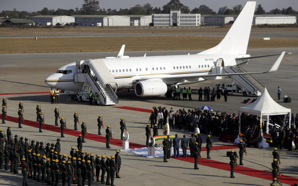 FILE - In this Sept. 11, 2019, file photo, a coffin carrying the body of Zimbabwe's former ruler Robert Mugabe arrives from Singapore, at the airport in Harare, Zimbabwe. The coronavirus pandemic could narrow one gaping inequality in Africa, where some heads of state and other elite jet off to Europe or Asia for health care unavailable in their nations but as global travel restrictions tighten, they might have to take their chances at home. (AP Photo/Themba Hadebe, File)