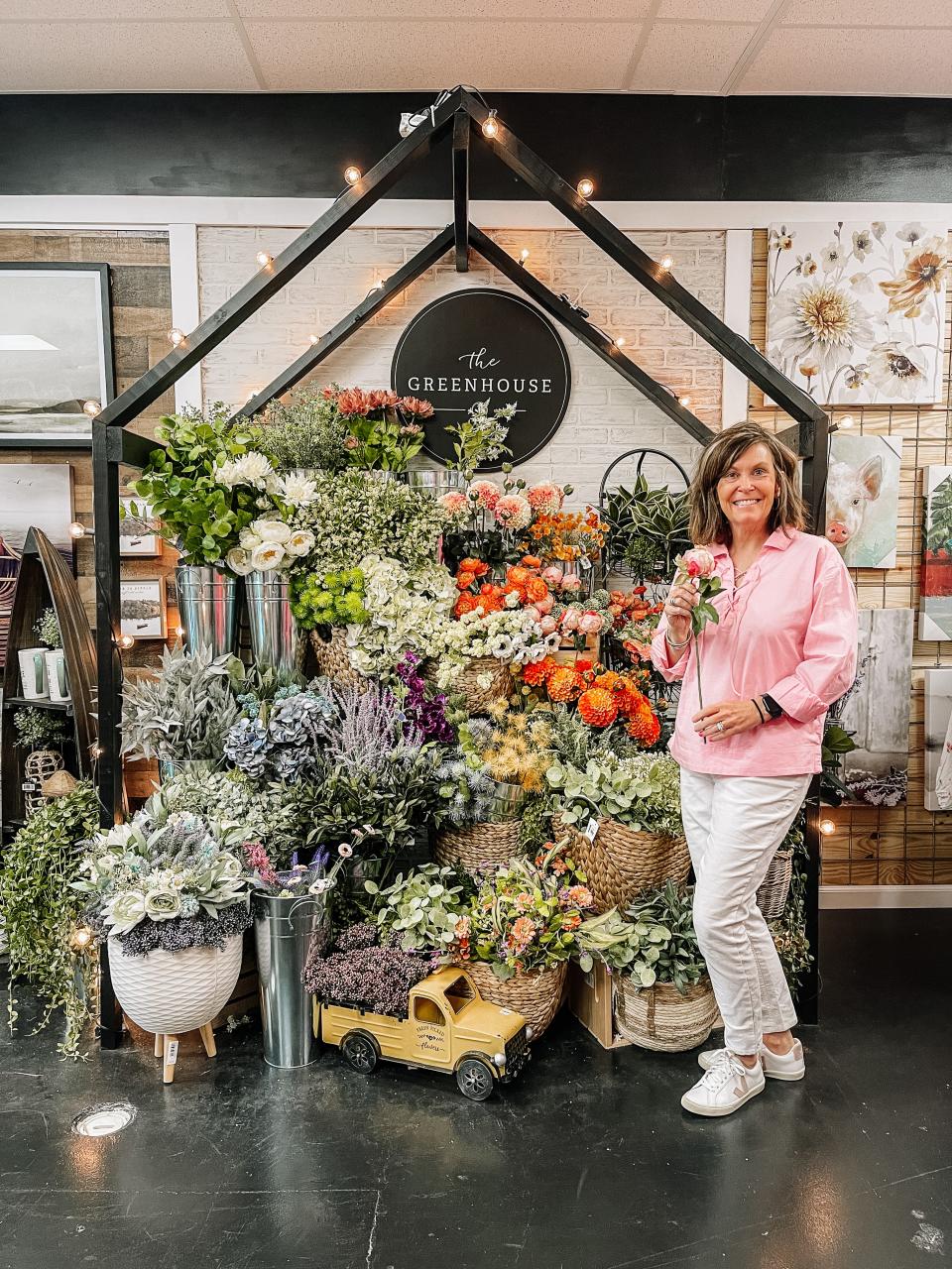 Jill Butler, co-owner of Halls Real Deals, in her favorite section of the store, The Greenhouse. Halls, July 5, 2023.