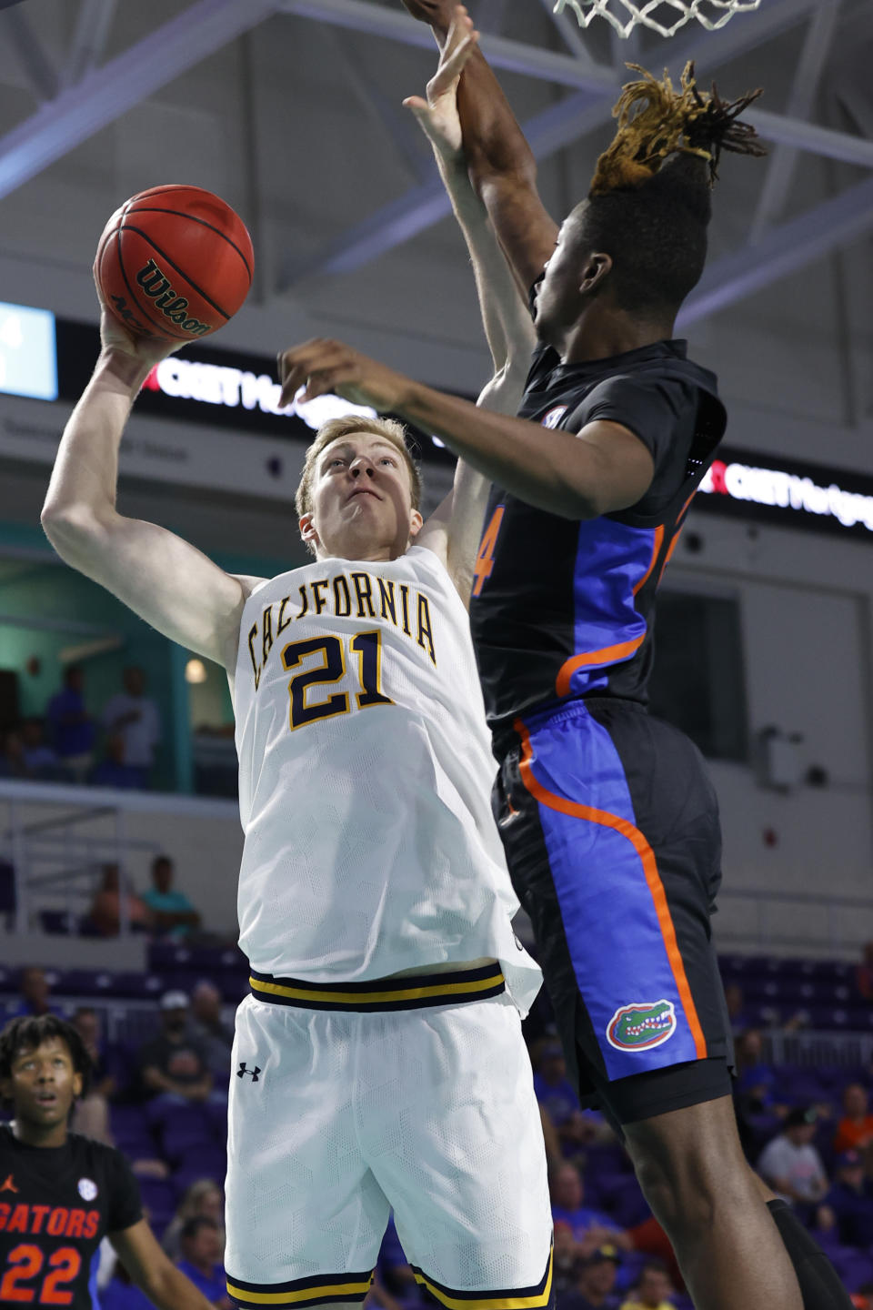 California forward Lars Thiemann (21) shoots past Florida guard Kowacie Reeves (14) during the second half of an NCAA college basketball game on Monday, Nov. 22, 2021, in Fort Myers, Fla. (AP Photo/Scott Audette)