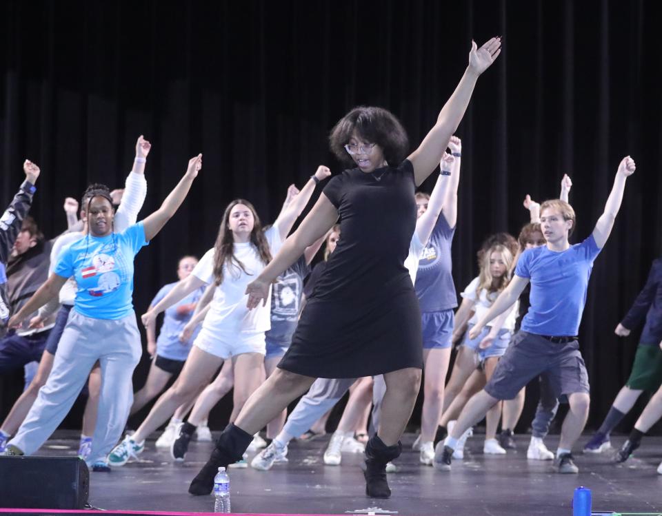 Assistant choreographer/director Ivy Johnson leads a Zumba warmup at Akron All-City Musical rehearsal on Monday at the Goodyear Theater in Akron.