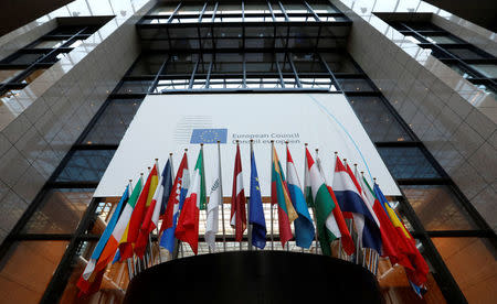 Flags are seen inside the European Council headquarters on the eve of a EU Summit in Brussels, Belgium December 14, 2016. REUTERS/Yves Herman