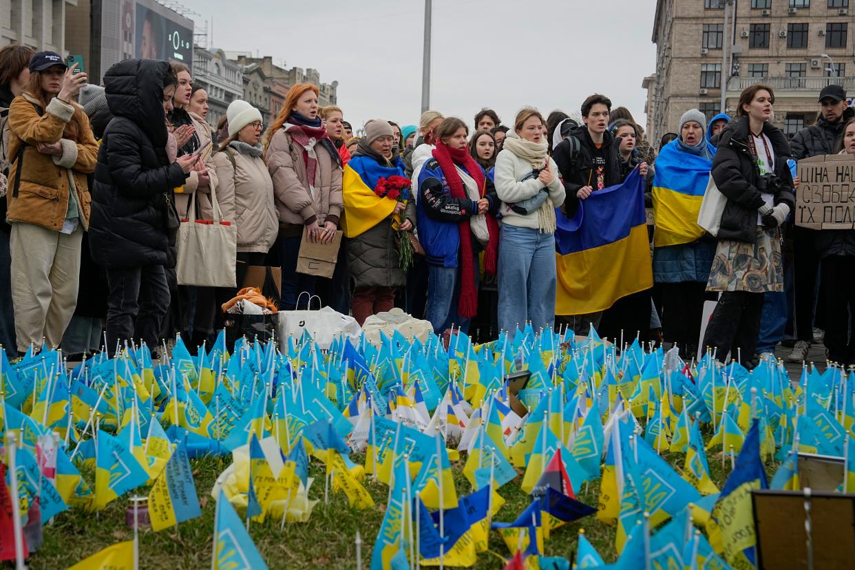 People stand at the memorial site for those killed during the war, near Maidan Square in central Kyiv, Ukraine, Saturday, Feb. 24, 2024. Ukraine is marking two years since Russia's full-scale invasion with a somber mood hanging over the country. On the battlefield, Ukrainian troops are running low on ammunition as they hope for further Western aid. (AP Photo/Efrem Lukatsky) ORG XMIT: XSG101