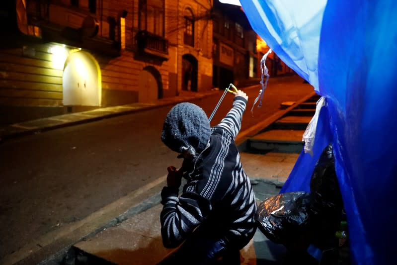 Protester uses a slingshot as they demonstrate against Bolivian President Evo Morales in La Paz