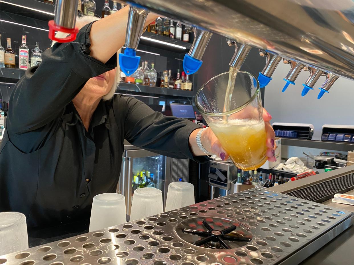 Toni Rivera drafts a NOUN Hotel Light Lager at ONE Bar in the NOUN Hotel in Norman during the April 17 launch party for the new beer with its producer, COOP Ale Works.