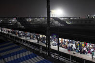 Indian passengers wait on a platform at a railway station in Allahabad, India.