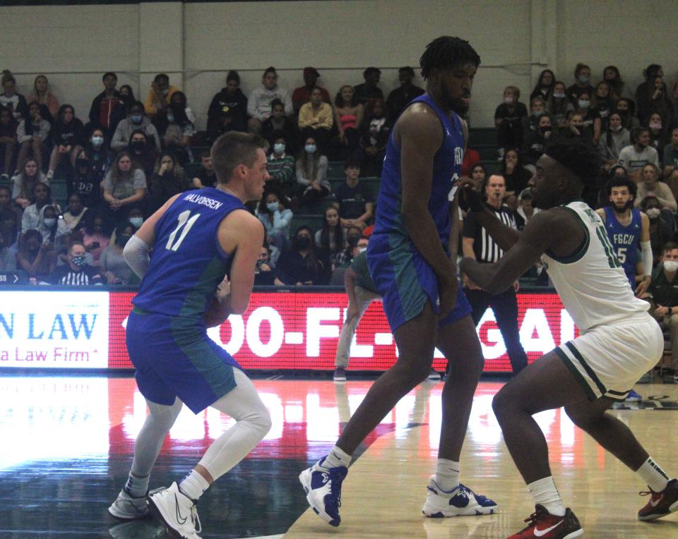 Florida Gulf Coast guard Matt Halvorsen (11) holds the ball as center Kevin Samuel (21) sets a screen against Jacksonville University guard Gyasi Powell (10) during a college men's basketball game on January 8, 2022. [Clayton Freeman/Florida Times-Union]