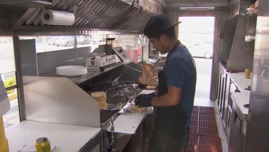 Manuel Antonio working at the Los Bros Tacos truck in Long Beach, California. (KTLA)