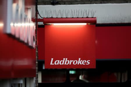 A sign hangs outside a branch of Ladbrokes in London, Britain December 22, 2017. REUTERS/Simon Dawson