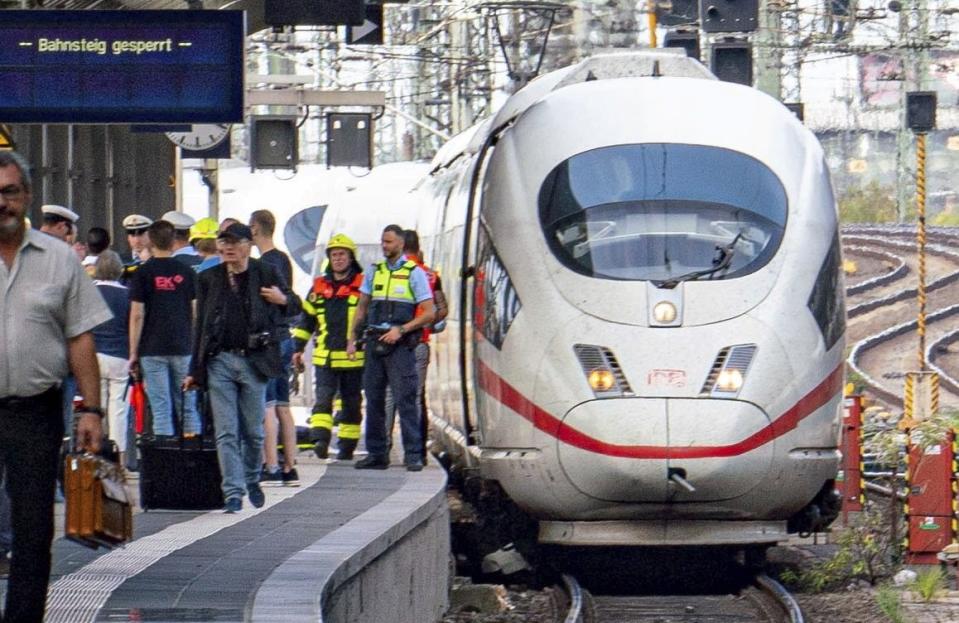 Firefighters and Police officers stay next to an ICE highspeed train at the main station in Frankfurt, Germany.