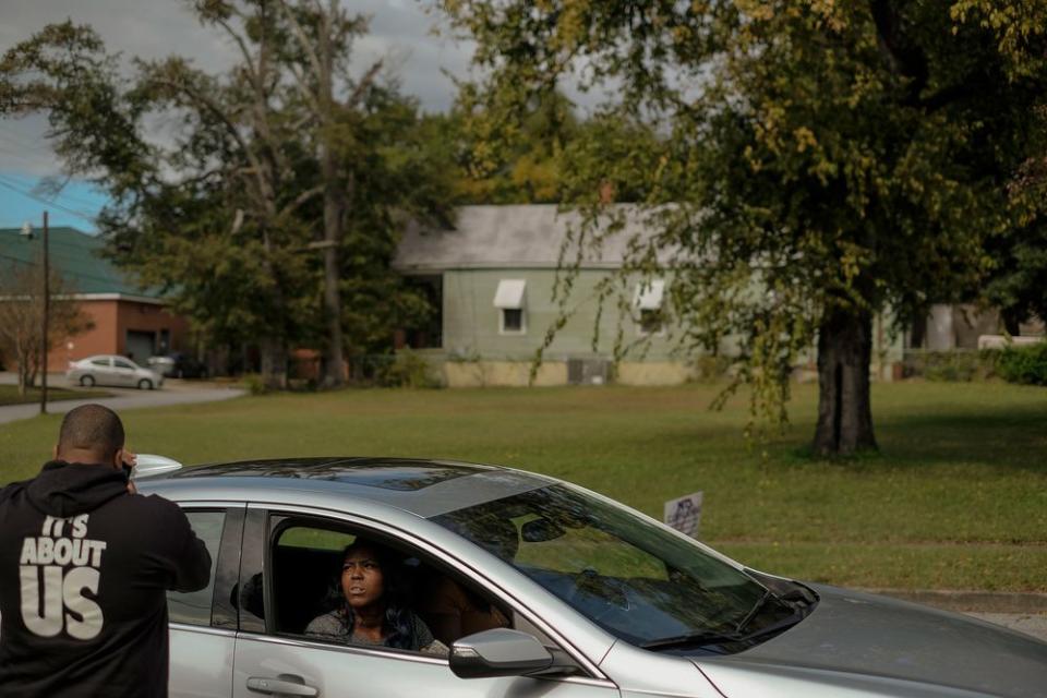 Cliff Albright with the Black Voters Matter organization checks the registration of Brittany Hill from Luthersville, Ga, on election day in Columbus, Ga. on Nov. 6, 2018.