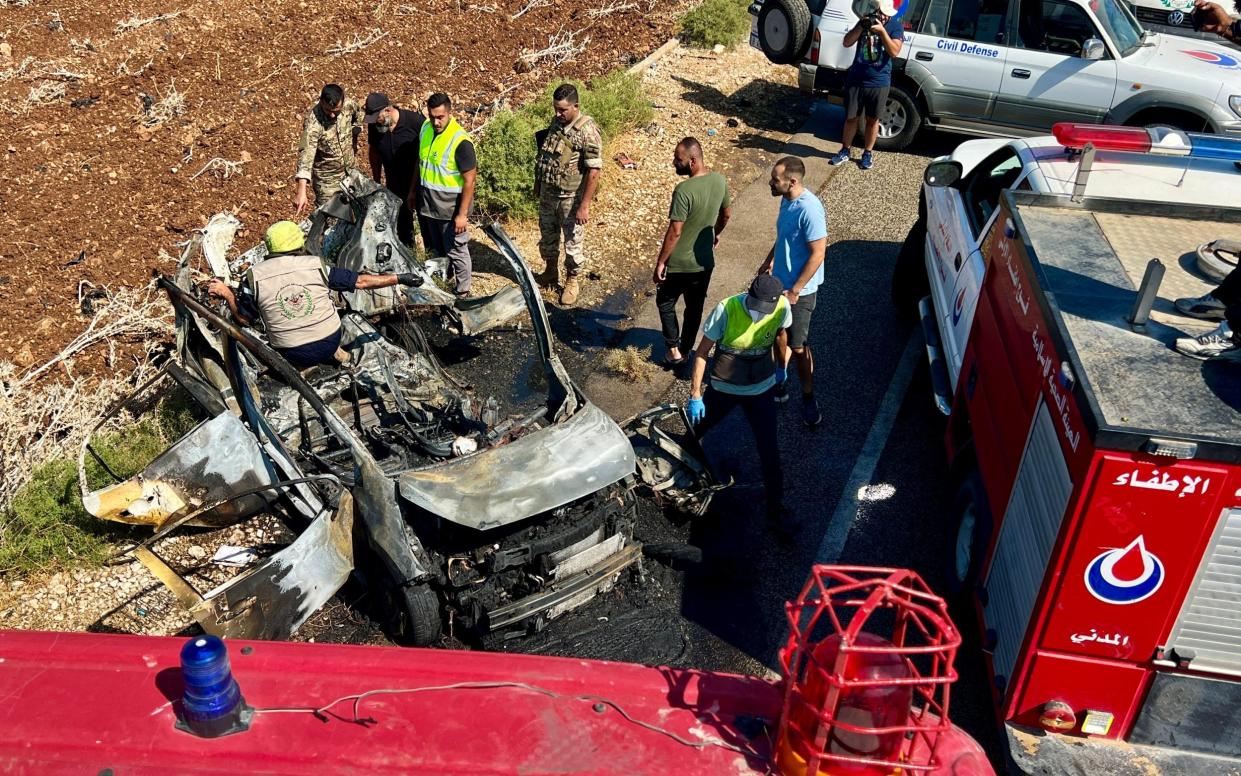 The remains of a car that was hit by an Israeli drone on the road leading to the southern Lebanese coastal town of Naqour