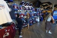 People look for merchandise in the team store in Ball Arena, Monday, June 27, 2022, in Denver after the Colorado Avalanche defeated the Tampa Bay Lightning in Game 6 of the Stanley Cup Final to claim the NHL hockey championship. (AP Photo/David Zalubowski)